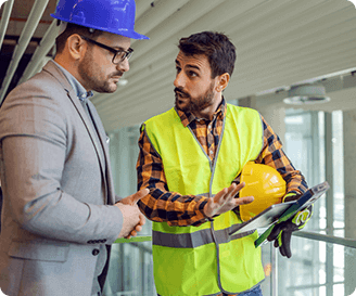 Safety leader and worker talking about micro-observation insights on site.