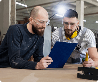 Workers reviewing a safety checklist as part of a behavior-based safety program.